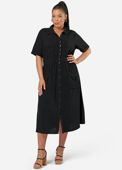Curve model wearing a black shirt dress