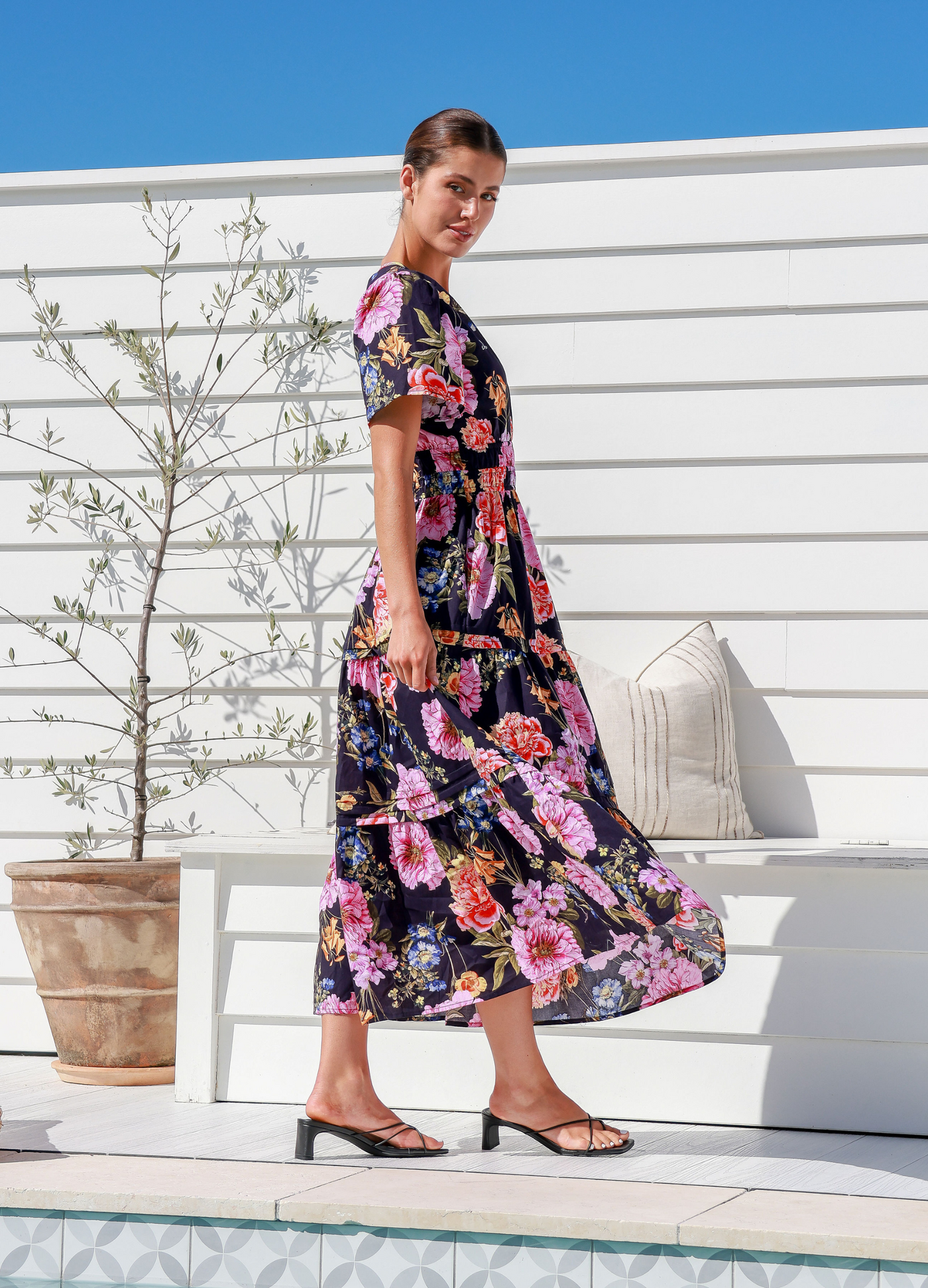 Model wearing the floral print short sleeve button top label of love aleksa dress