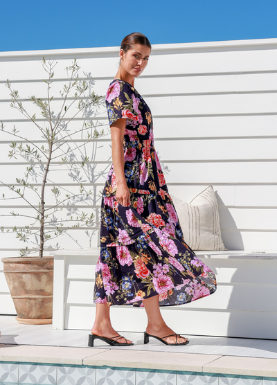 Model wearing the floral print short sleeve button top label of love aleksa dress