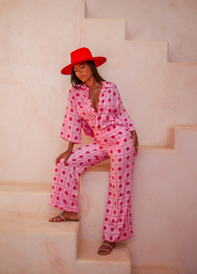 Model wearing the pink and red spanish sun blouse from Palm Collective