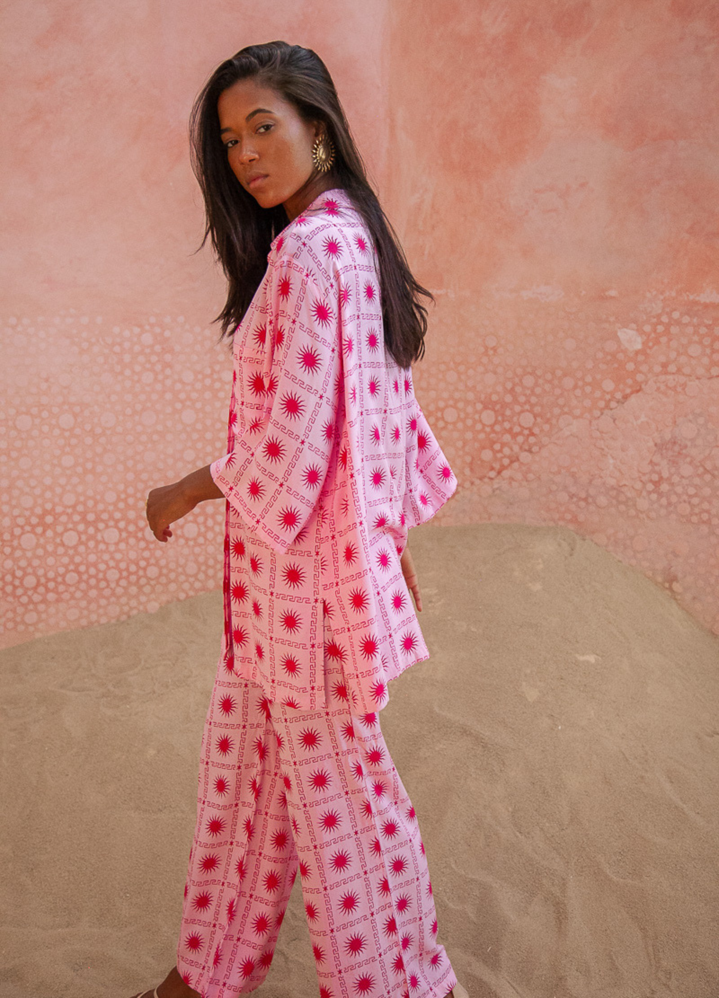 Model wearing the spanish sun pants in pink and red
