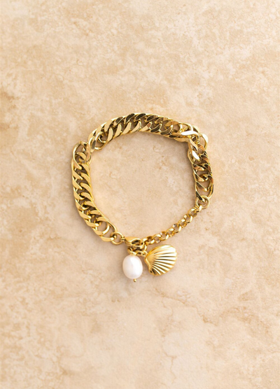 Gold chain link bracelet featuring a pearl and shell charm