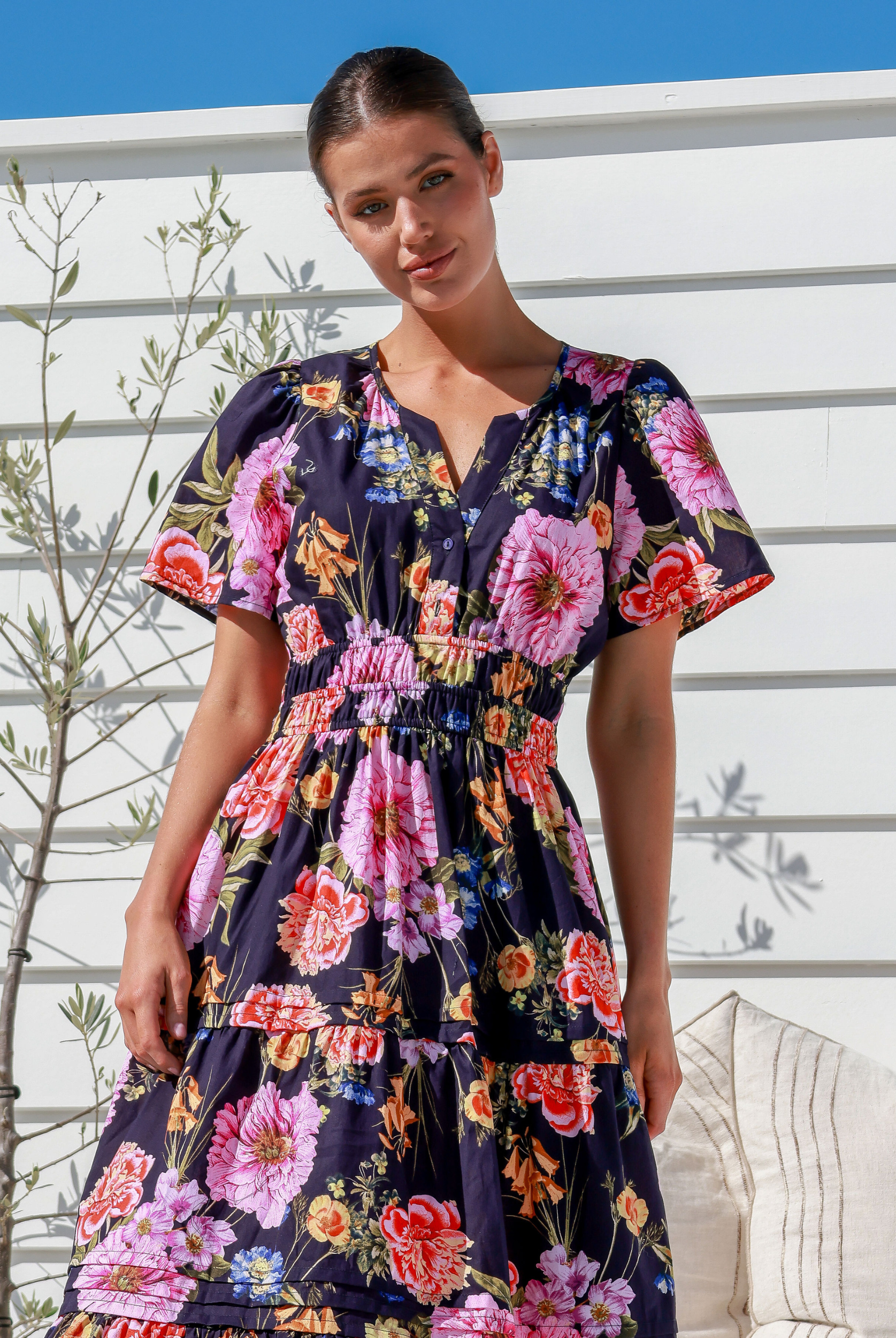 Model wearing the floral print short sleeve button top label of love aleksa dress