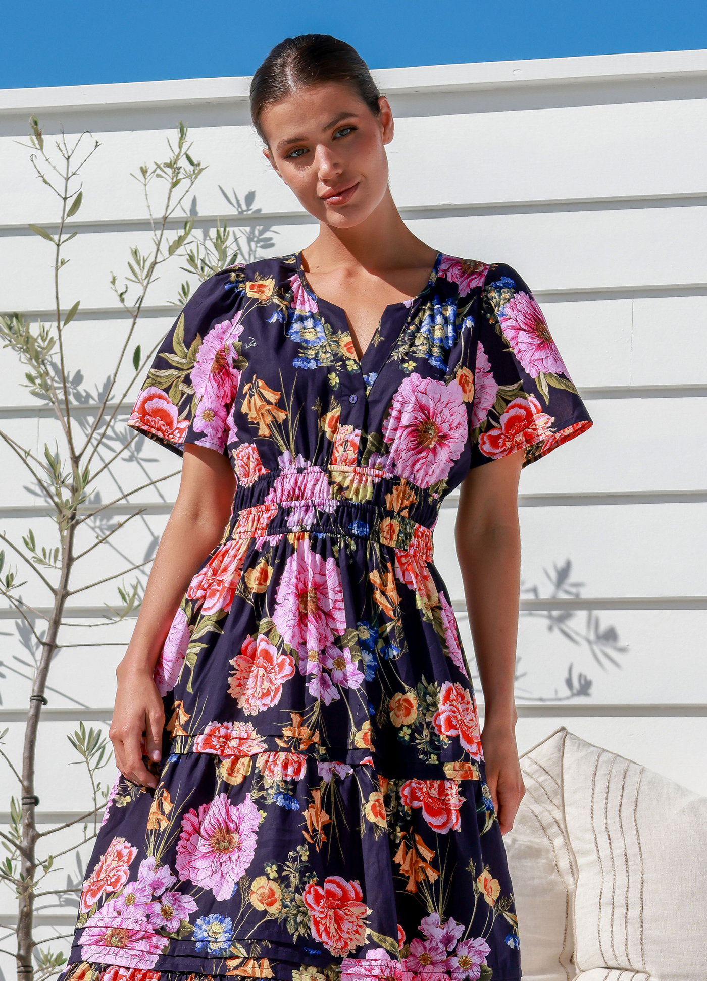 Model wearing the floral print short sleeve button top label of love aleksa dress