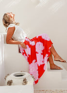 Red base floral midi skirt with white and pink flowers and ties at the waistband