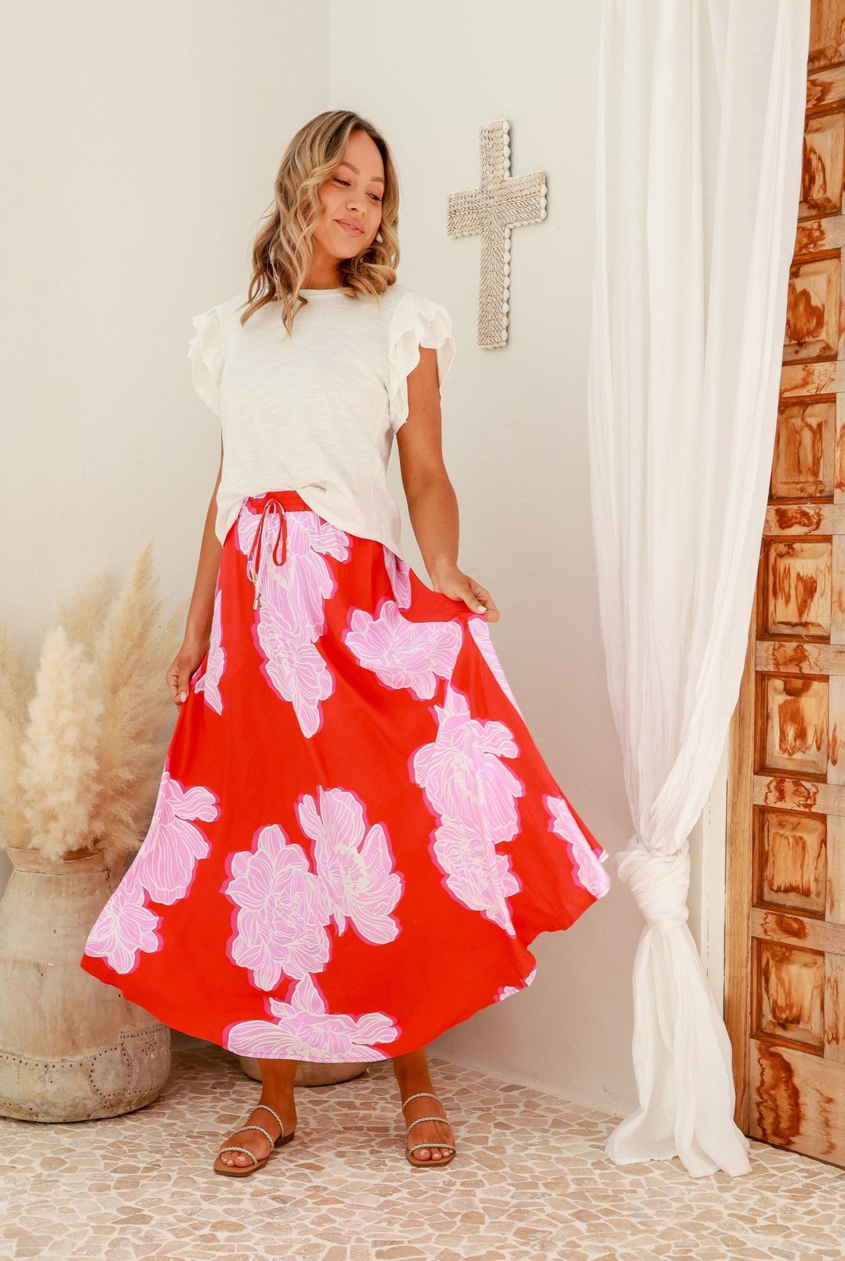 Red base floral midi skirt with white and pink flowers and ties at the waistband