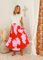 Red base floral midi skirt with white and pink flowers and ties at the waistband