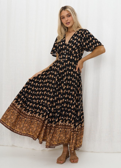 Model wearing the Iris Maxi Gypset Dress in black print with button front and cap sleeve