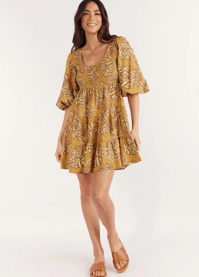 Model wearing the short sleeve seashell print mini dress from Girl and the Sun