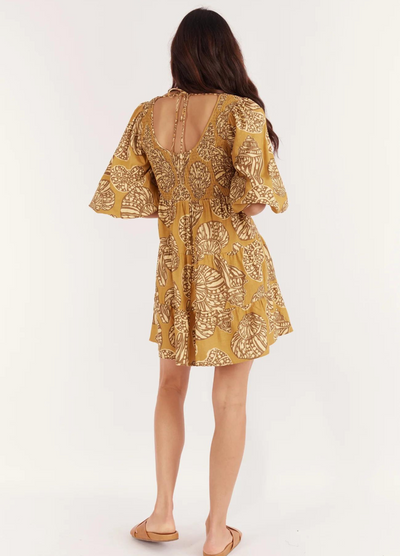 Model wearing the short sleeve seashell print mini dress from Girl and the Sun