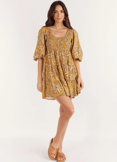 Model wearing the short sleeve seashell print mini dress from Girl and the Sun