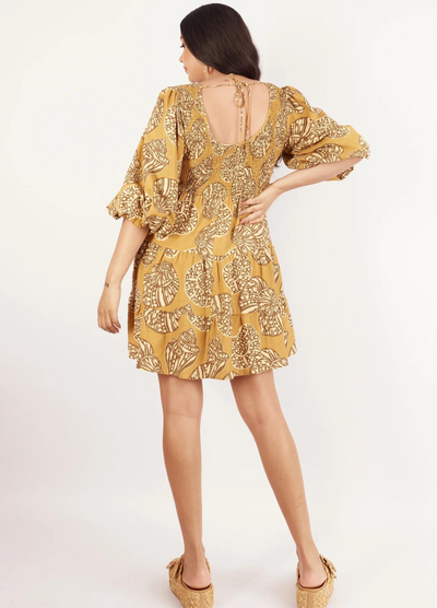 Model wearing the short sleeve seashell print mini dress from Girl and the Sun