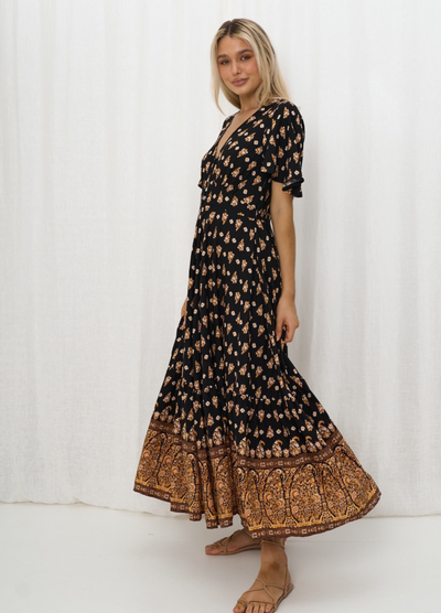 Model wearing the Iris Maxi Gypset Dress in black print with button front and cap sleeve