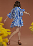 Model wearing blue and white shirt dress from Bohemian Traders