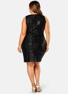 Curve woman wearing a sequin mini dress with wrap front detail