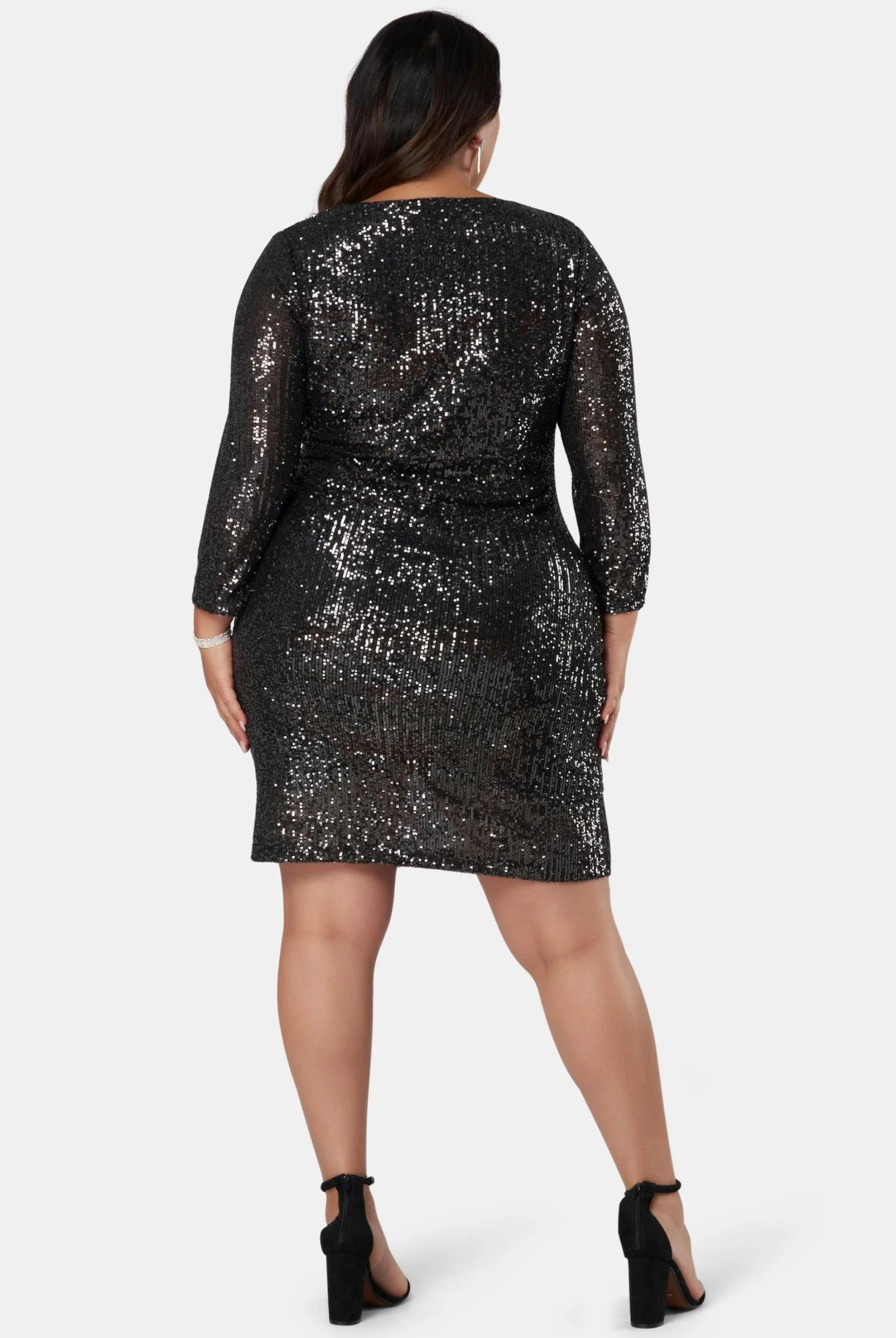 Curve Model wearing the Smoking Hot Sequin wrap dress in black mini length