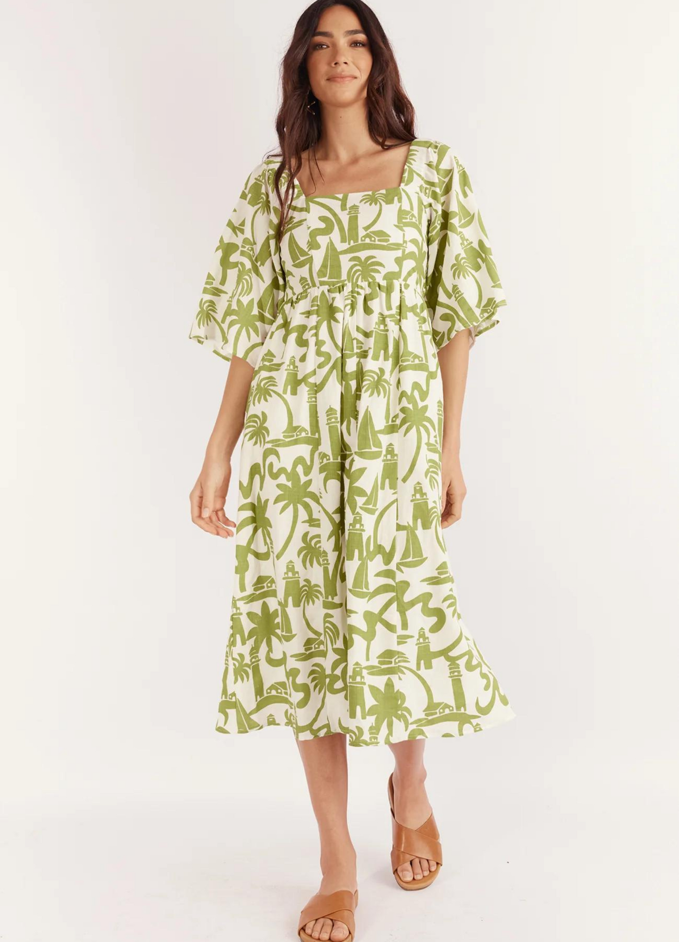 Model wearing the Dulce Midi Dress from Australian Brand Girl in the Sun in green and white lighthouse print