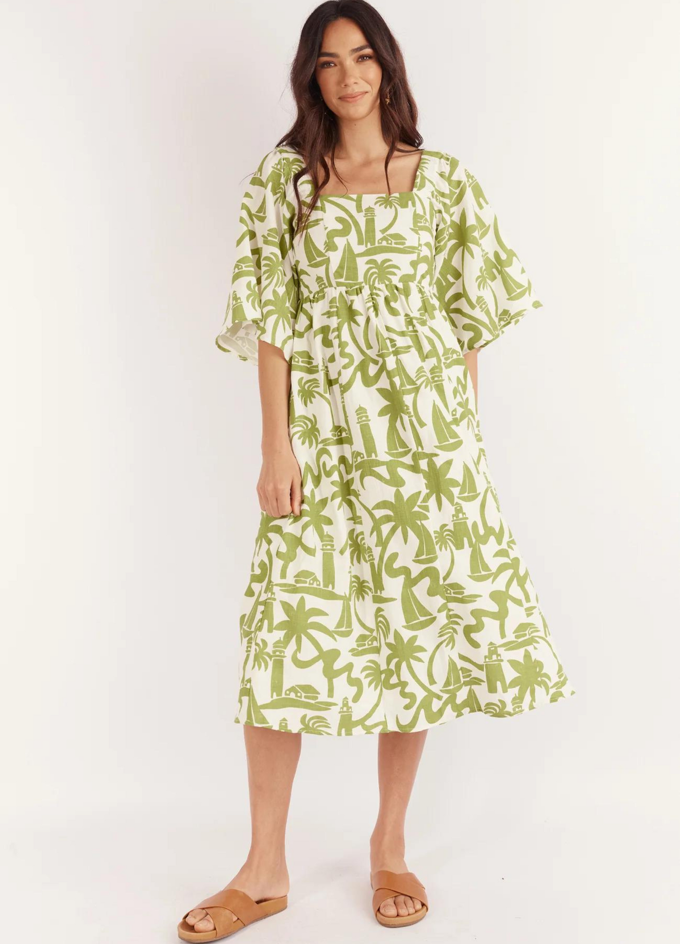 Model wearing the Dulce Midi Dress from Australian Brand Girl in the Sun in green and white lighthouse print