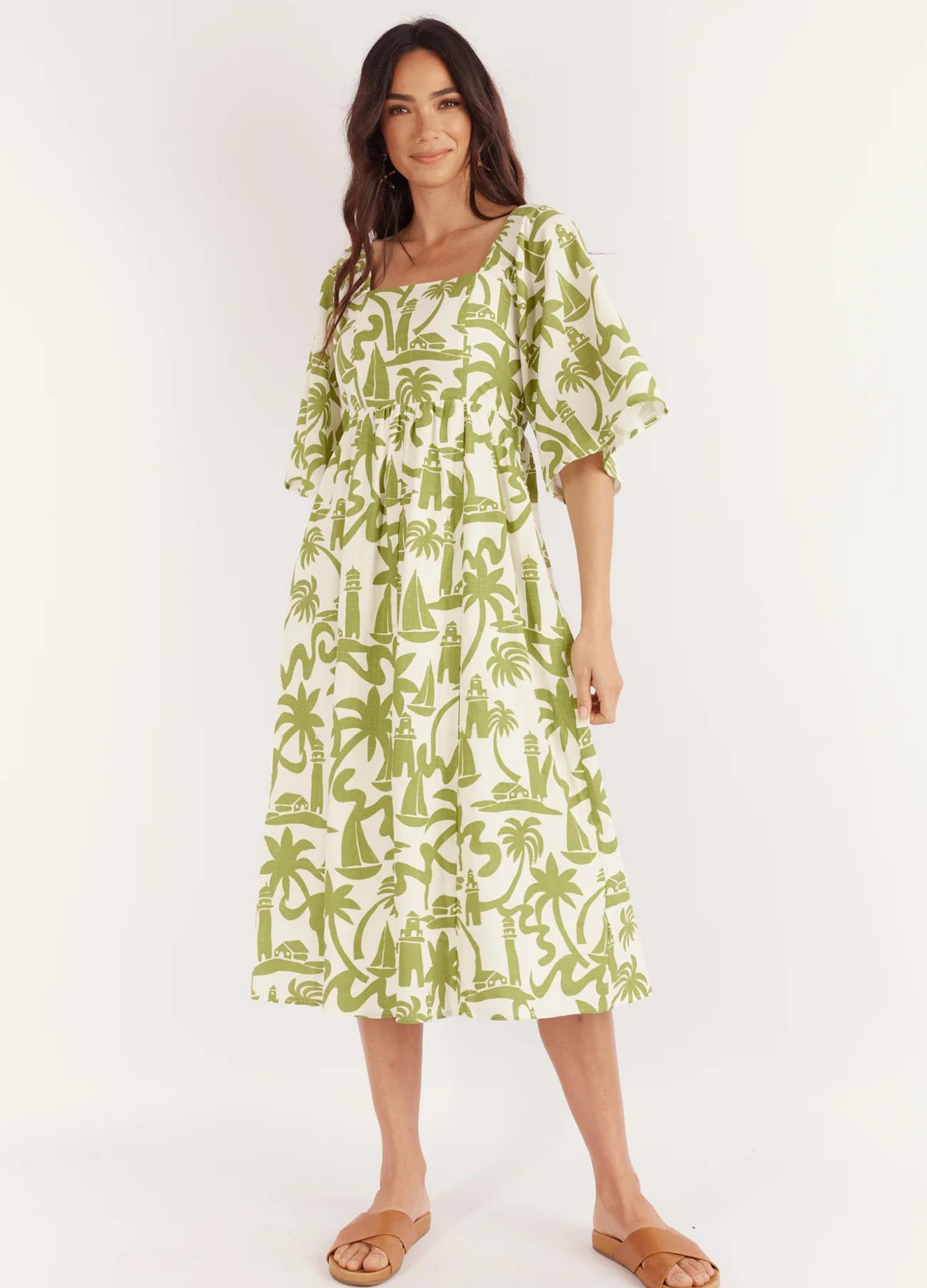Model wearing the Dulce Midi Dress from Australian Brand Girl in the Sun in green and white lighthouse print
