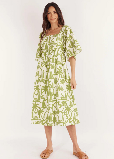 Model wearing the Dulce Midi Dress from Australian Brand Girl in the Sun in green and white lighthouse print