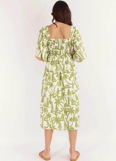 Model wearing the Dulce Midi Dress from Australian Brand Girl in the Sun in green and white lighthouse print