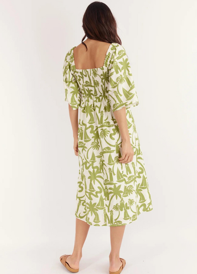 Model wearing the Dulce Midi Dress from Australian Brand Girl in the Sun in green and white lighthouse print