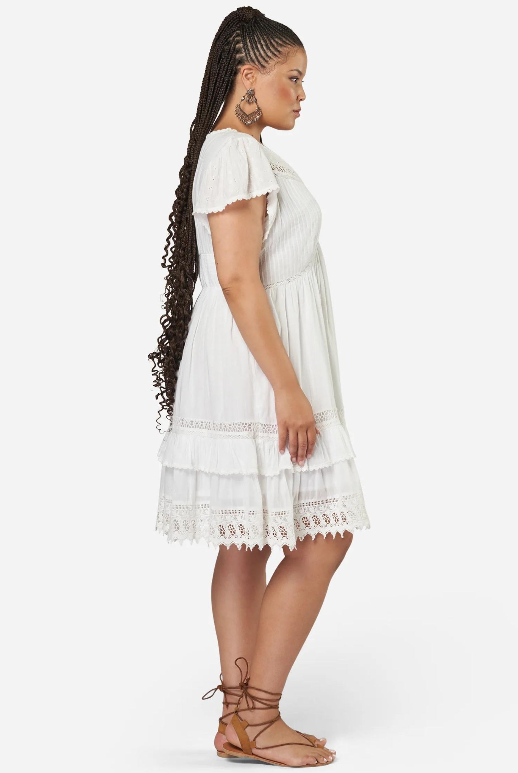 Plus sized model wearing white boho mini dress