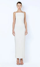 Woman wearing a white sleeveless dress on a white background