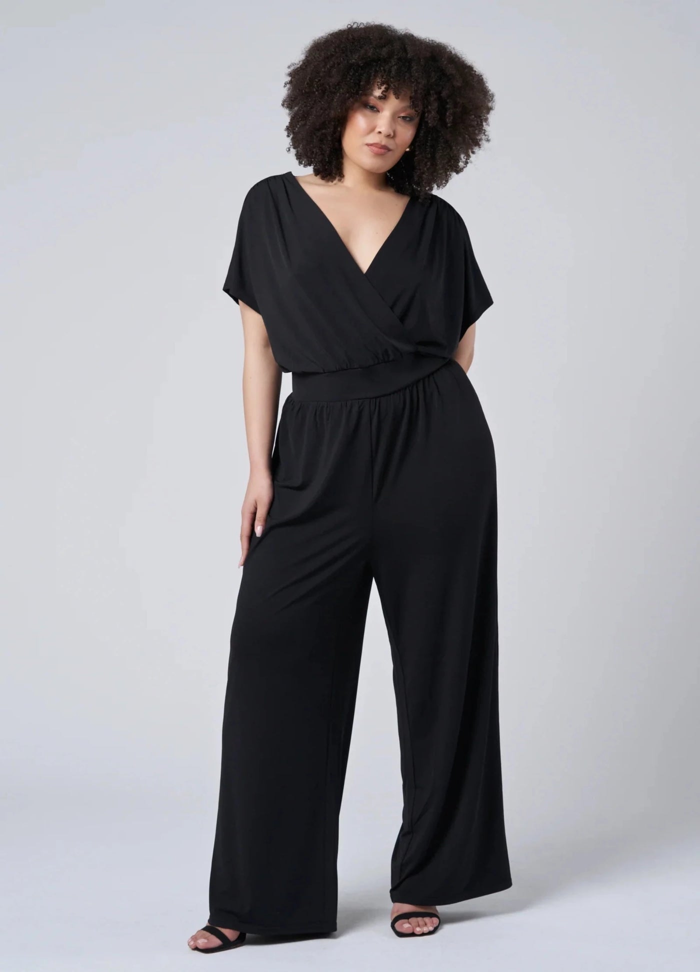 Black jersey jumpsuit with wrap top detail and low back