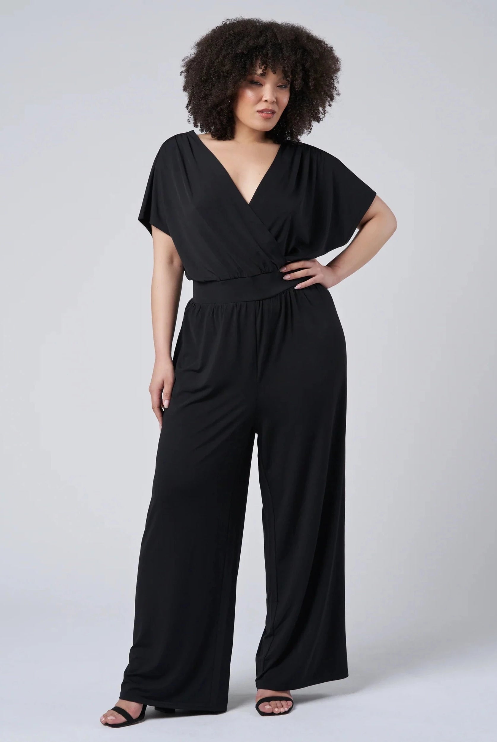 Black jersey jumpsuit with wrap top detail and low back