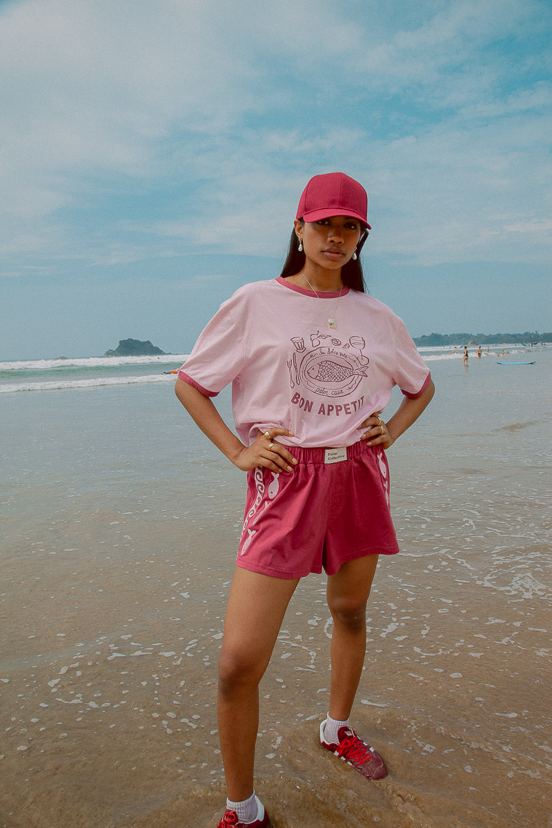 Pink tee shot on a beach from Palm Collective