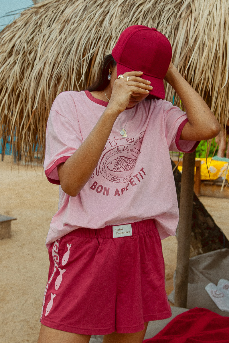 Pink tee shot on a beach from Palm Collective