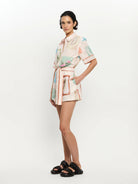 Woman wearing a patterned outfit on a white background