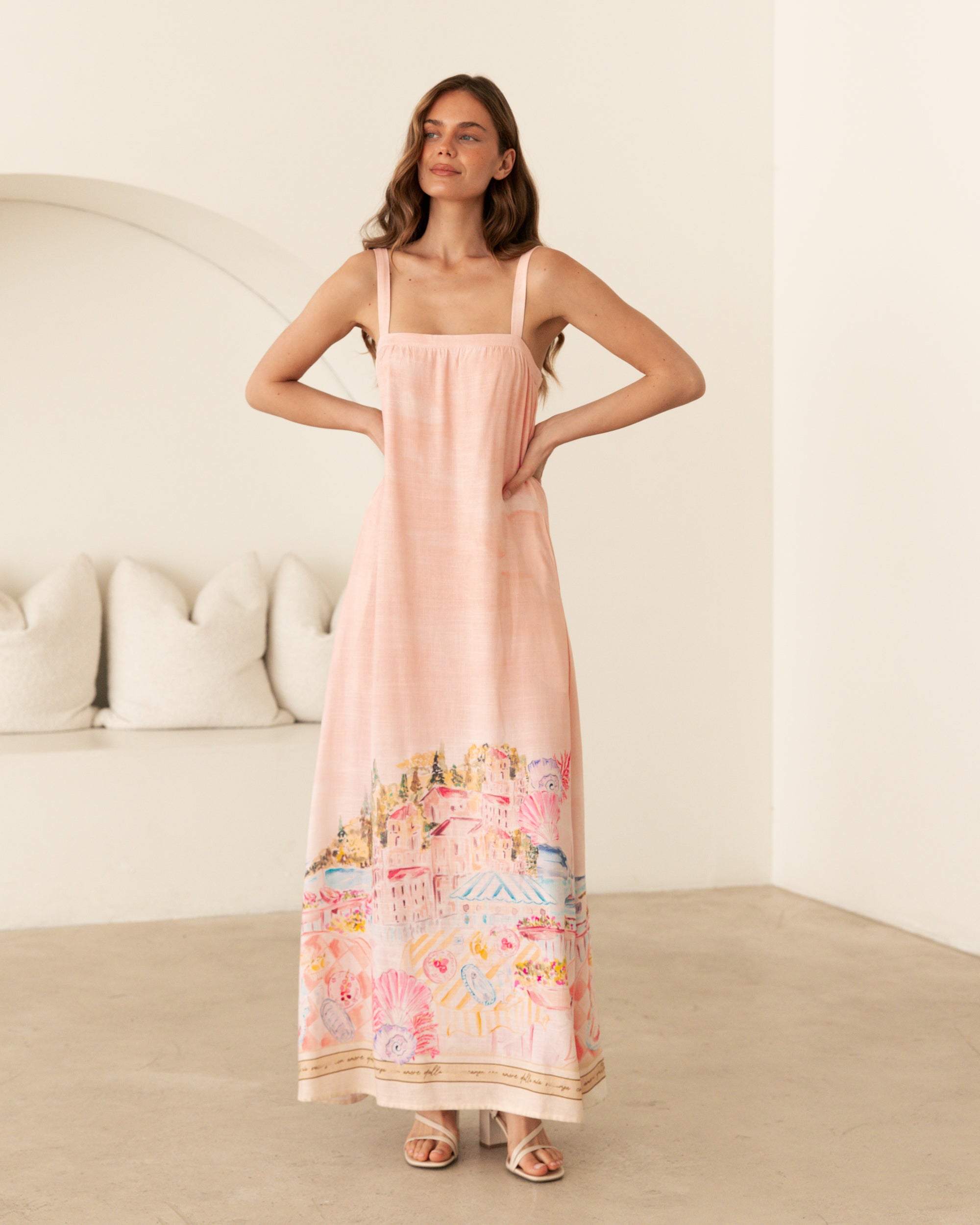 Ebby and I Luciana Maxi Dress worn by model on a white background. Coral placement print maxi with adjustable straps.