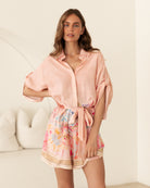 Woman wearing the Luciana Playsuit in Coral