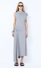 Woman wearing a gray dress on a white background Ema Asym Dress - Grey Blue