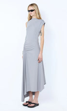 Woman wearing a gray dress with a white background Ema Asym Dress - Grey Blue