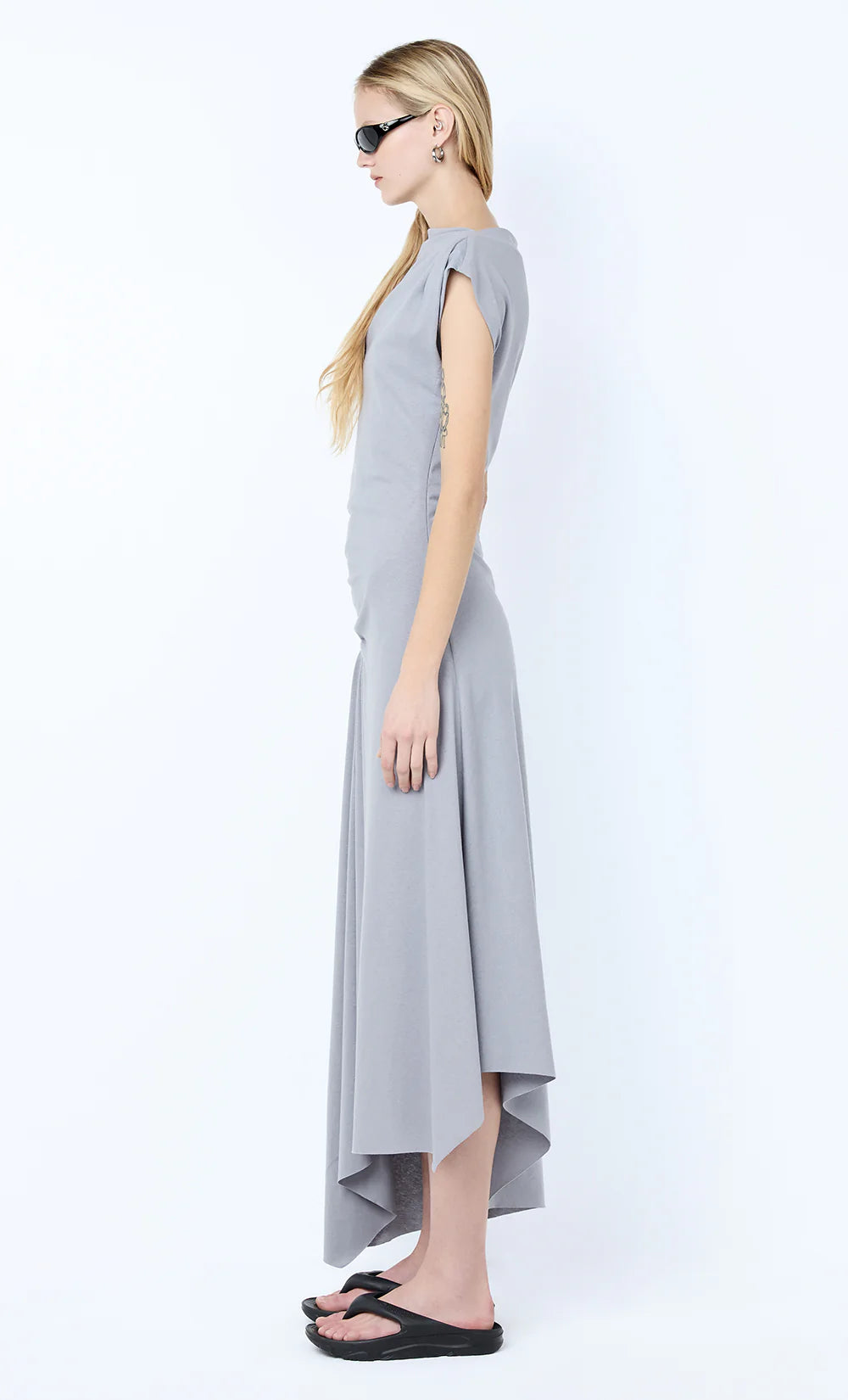 Woman wearing a gray dress on a white background