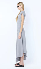 Woman wearing a gray dress on a white background
