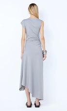 Woman wearing a light gray dress on a white background