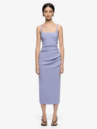 Woman wearing a light purple dress on a white background
