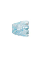 Blue and white marbled hair clip on a white background