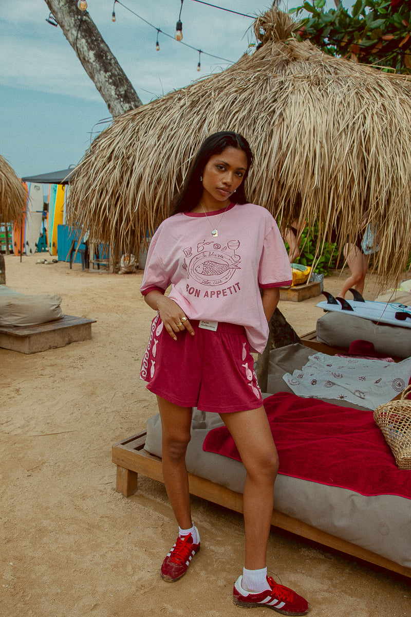 Pink tee shot on a beach from Palm Collective