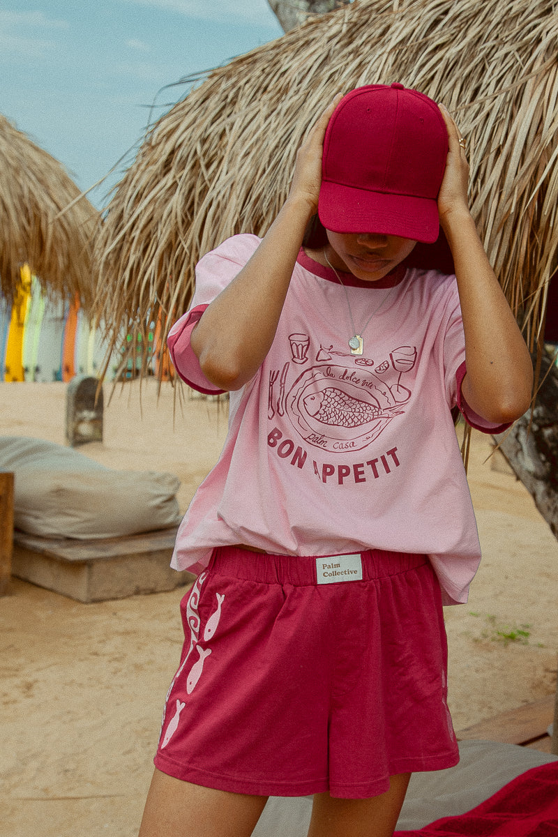 Pink tee shot on a beach from Palm Collective