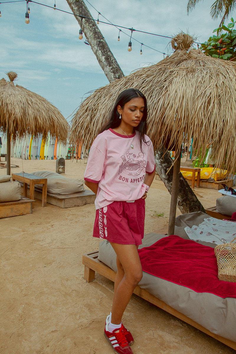 Pink tee shot on a beach from Palm Collective