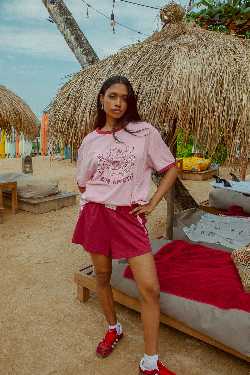 Pink tee shot on a beach from Palm Collective