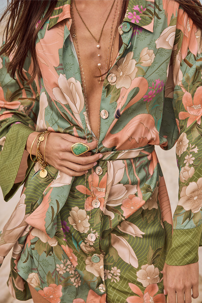 Person wearing a floral patterned outfit with a focus on the clothing design.