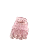 A pink, glittery hair clip with a solid pattern.