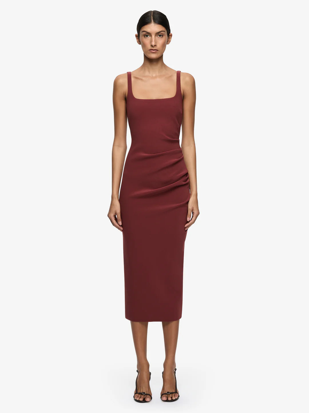 Woman wearing a burgundy dress on a white background