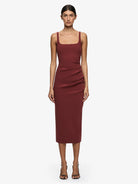 Woman wearing a burgundy dress on a white background